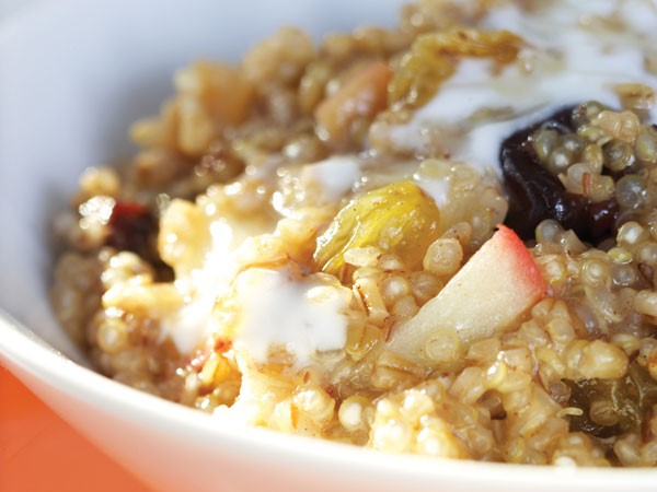 Quinoa oatmeal topped with fresh and dried fruit