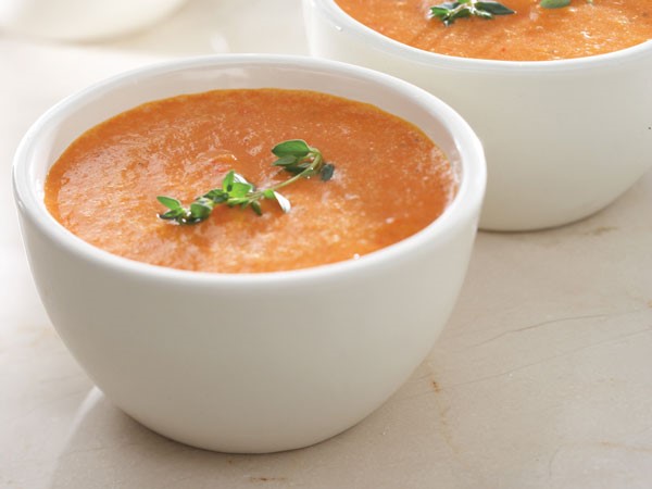 White bowl filled with creamy roasted tomato soup