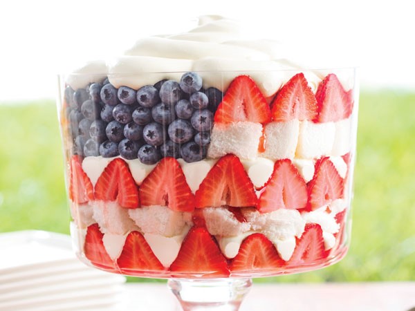 Trifle layered with sliced strawberries, blueberries, and angel food cake