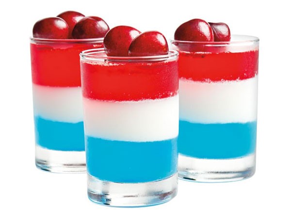 Red, white, and blue jello in shot glasses
