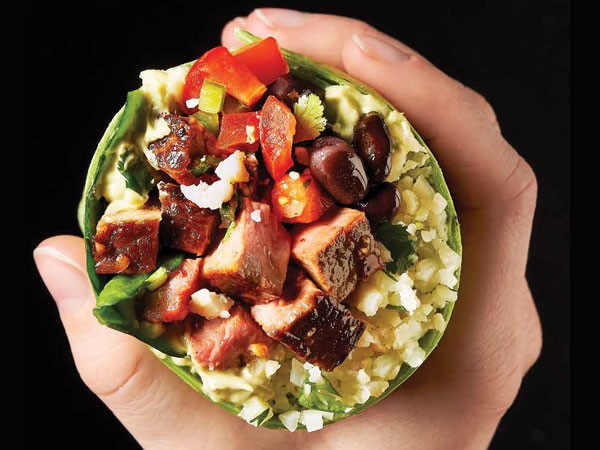 Spinach tortilla filled with beef, cauliflower rice, beans, avocado and pico de gallo