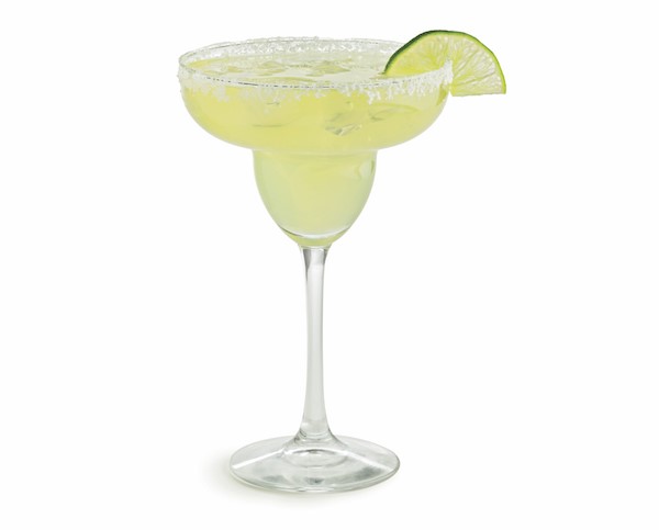 Salt-rimmed margarita glass filled with authentic margarita with a lime wedge