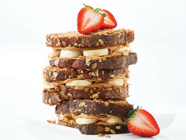 Stack of banana bread french toast layered with peanut butter and banana slices 