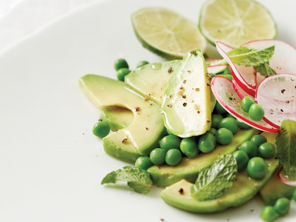 Avocado-radish-pea salad topped with freshly ground black pepper