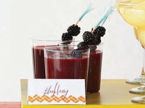 Glasses filled with blackberry margaritas and garnished with fresh blackberries