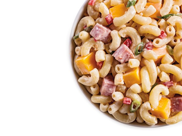 Diced ham and cheese pasta salad in white bowl