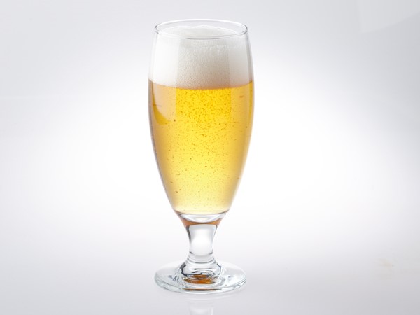 American wheat light beer in glass with foam