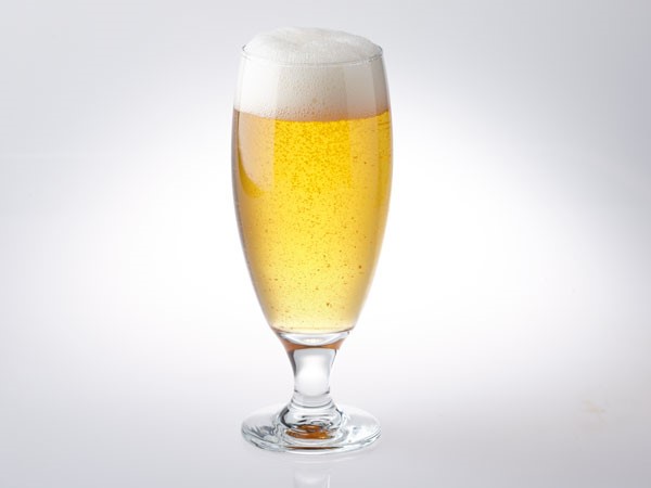 American wheat light beer in glass with foam