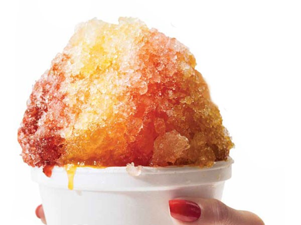 Shaved red, orange and yellow Ice in a styrofoam cup