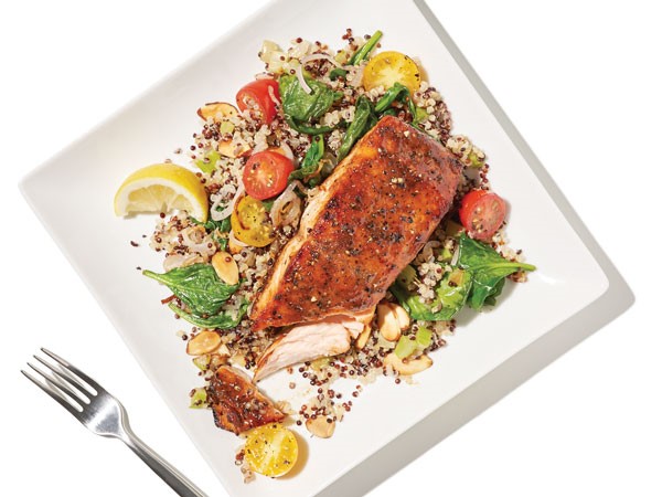 Plate of salmon over pilaf and spinach