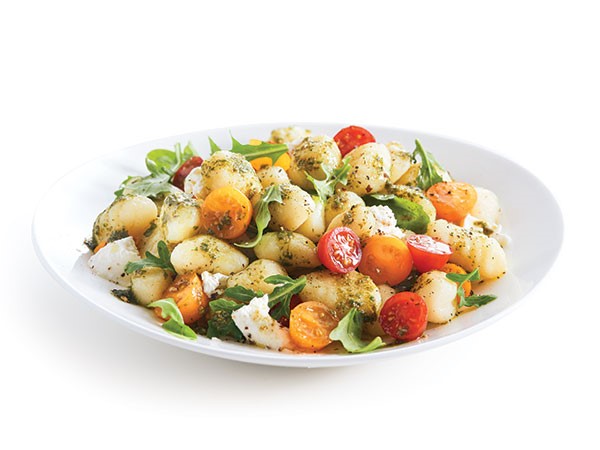 Bowl of salad mixed with gnocchi and grape tomatoes