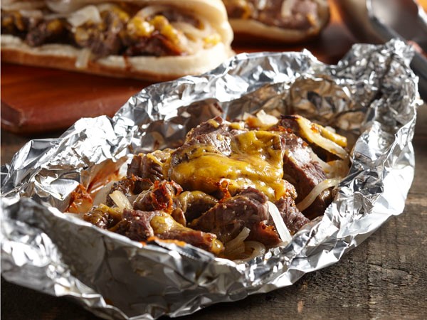 Aluminuim foil filled with beef sirloin, onions and melted cheddar cheese