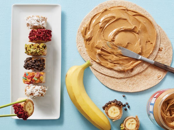 Banana sushi rolls topped with crushed cereal, coconut or nuts