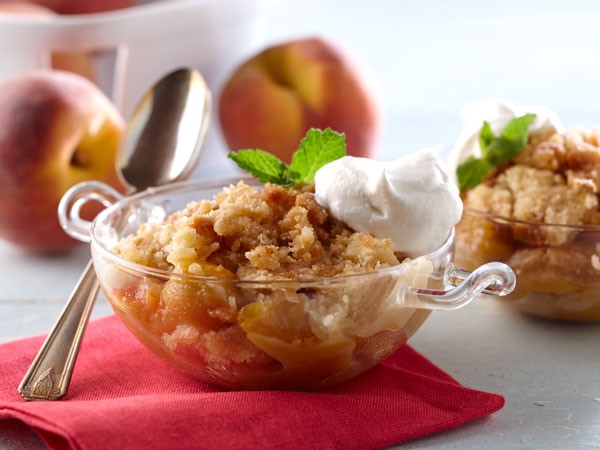 Bowl of Peach Crumble, Topped with Whiskey Whipped Cream
