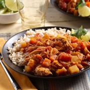 Plate of chicken vindaloo served with a side of rice