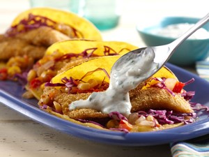 Platter of breaded fish tacos topped with hatch pepper cream
