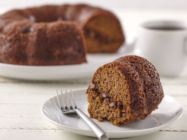 Slice of butternut squash coffee cake on a plate with a fork