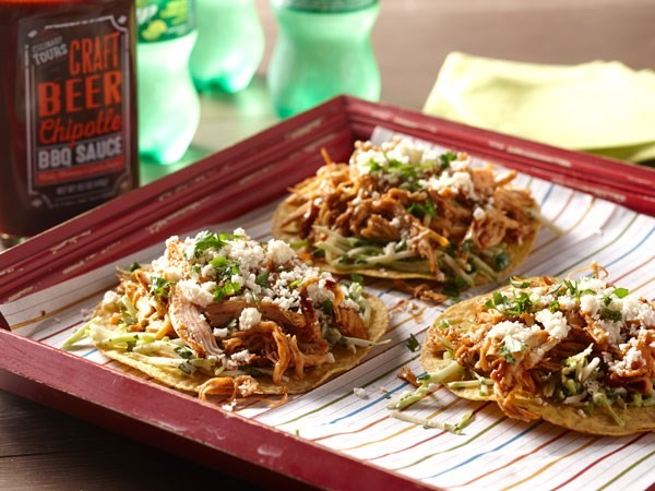 Red tray of beer-marinated chicken toastadas