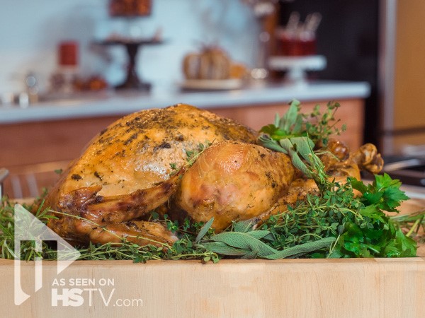 Whole roasted turkey on a bed of herbs
