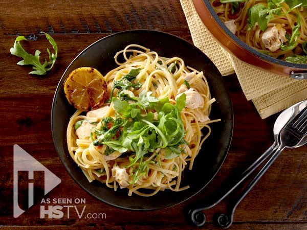 Cheesy chicken harissa pasta topped with arugula 