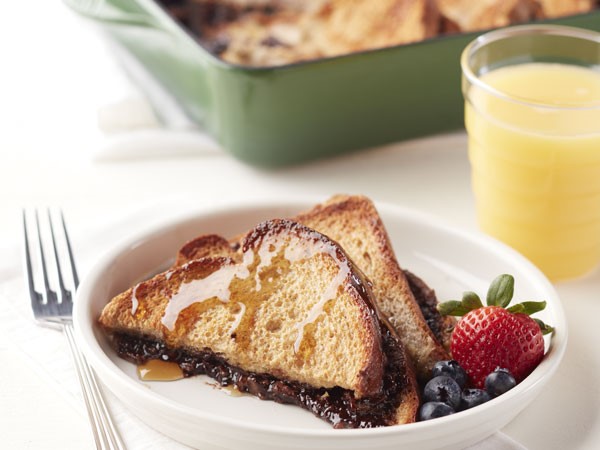 French toast stuffed with chocolate hazelnut spread on a plate with berries