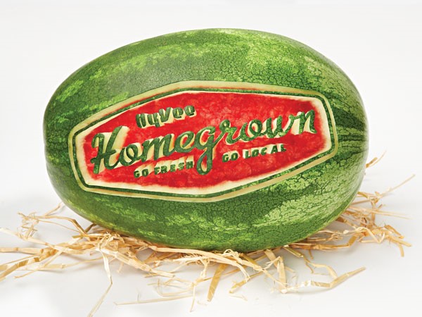 Whole watermelon with Homegrown logo carved into it.