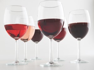 six wine glasses with different types of red wine