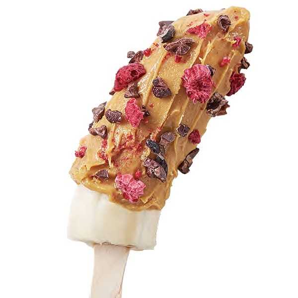 Frozen Banana Half on a Wooden Skewer topped with Freeze Dried Raspberries and Cacao Nibs