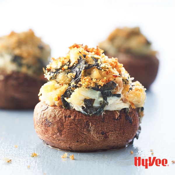 Crab-stuffed mushrooms topped with melted cheese