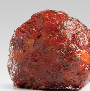 Single meatball topped with sauce