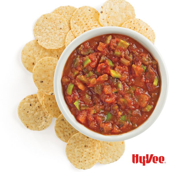 Bowl of salsa surrounded by tortilla chips