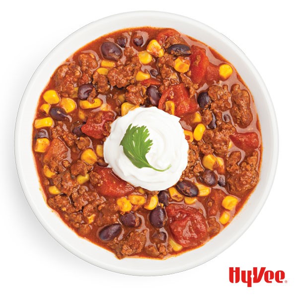 Bowl of Chili topped with Sour Cream and Cilantro