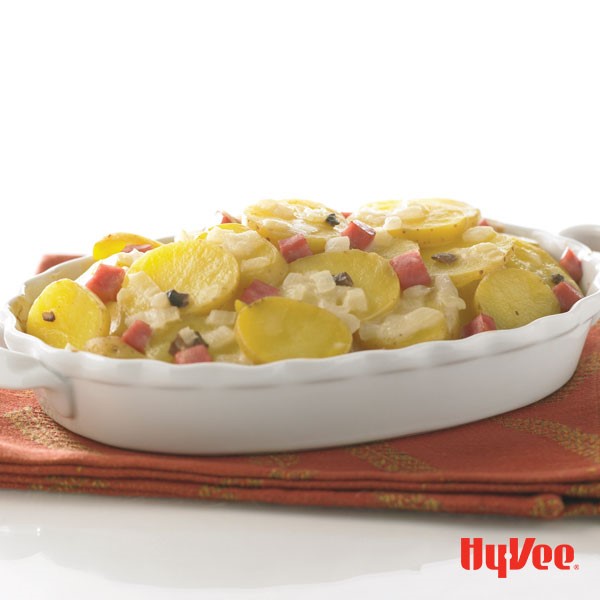 Sliced potatoes topped with chopped ham and onions