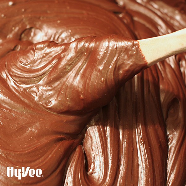 Wooden spoon in chocolate frosting