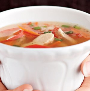 Bowl of soup with chicken, broth and peppers