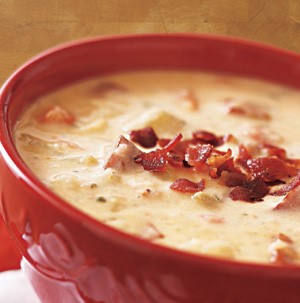 Bowl of Cheesy Potato Soup garnished with Bacon Bits