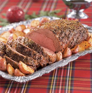 Herb rubbed prime rib with quartered roasted red potatoes on the side