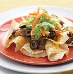 Tortilla Chips topped with Ground Beef, Black Olives, Lettuce and Cheese