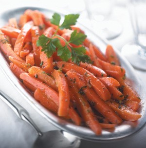 Thinly cut roasted carrots garnished with fresh herbs