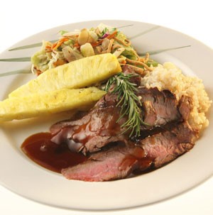 Dish of flank steak served with vegetables and rice