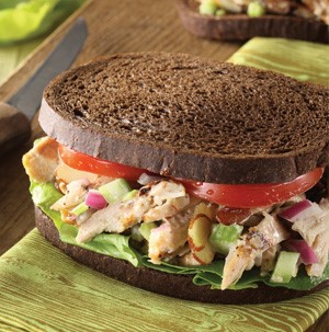 Chicken Almond Salad sandwiched between two slices of Pumpernickel