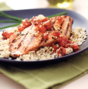 Rice topped with grilled salmon fillet and diced tomatoes