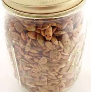 Savory roasted pumpkin seeds in a glass mason jar