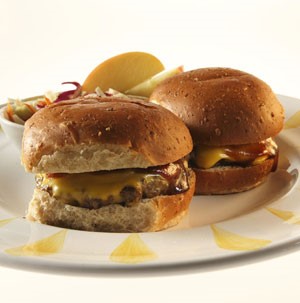 Plate of BBQ cheeseburger sliders with a side of coleslaw