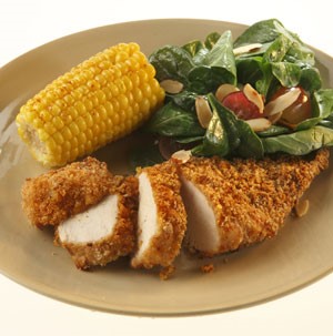Crispy Breaded Chicken served with Corn on the cob and side Salad
