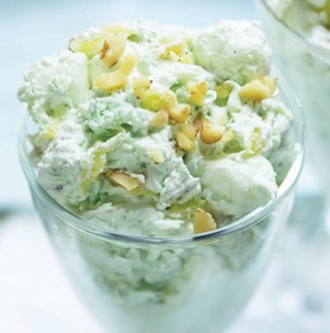 Green marshmallow salad topped with chopped nuts