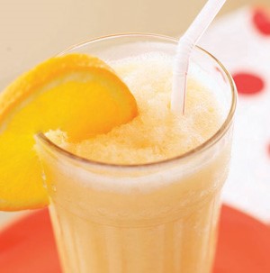 Creamy Orange-Mango Smoothie served with Orange Slice and Straw