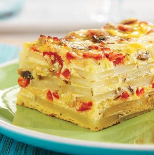 Baked layered potato strata with egg and cheese on green plate