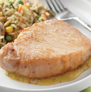 Honey-Dijon glazed pork chops with rice and mixed vegetables on the side