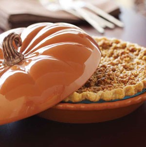 Pumpkin cheesecake pie served in a pumpkin pie serving dish